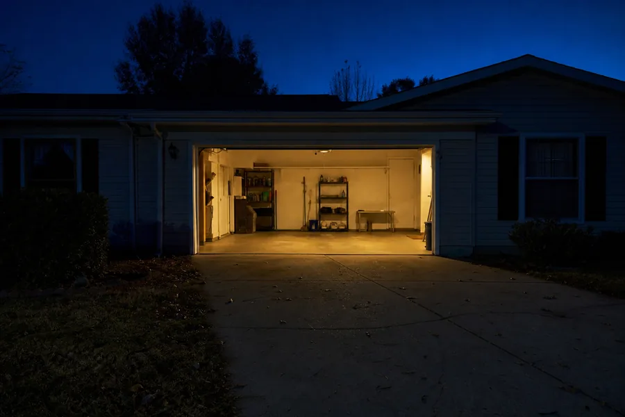 A garage door stuck open at night in New York, NY