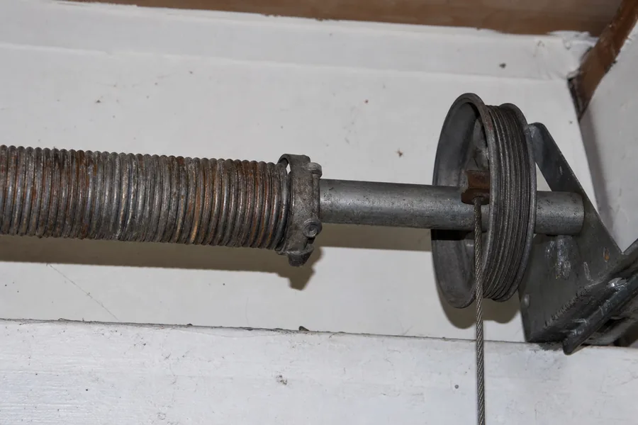 Torsion spring, shaft and cable drum above a garage door in New York, NY