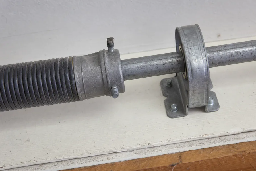 Torsion spring, winding cone and center bearing above a garage door in New York, NY