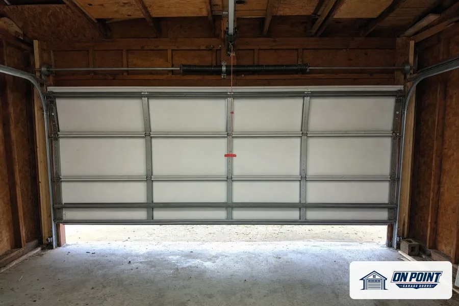 New white insulated garage door seen from inside the garage