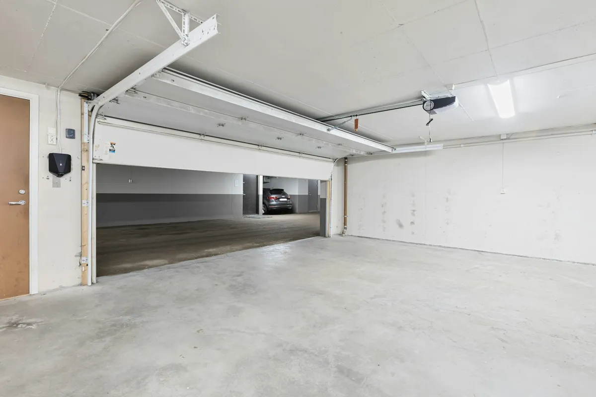 Garage interior with the opener rail running to an open door