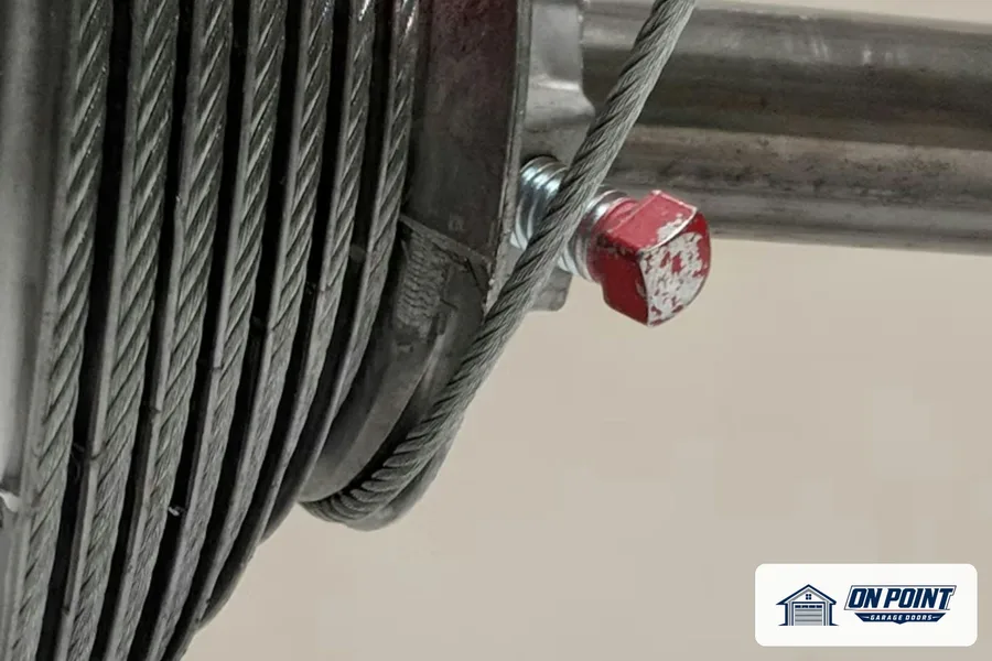 Lift cable wound on the drum at the end of a torsion spring shaft