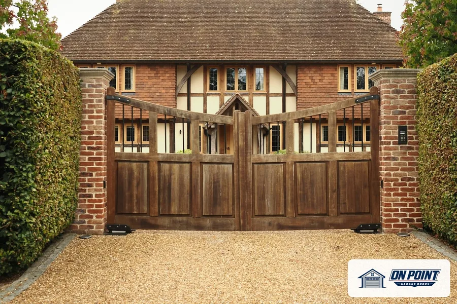 Wooden double driveway gate between brick pillars